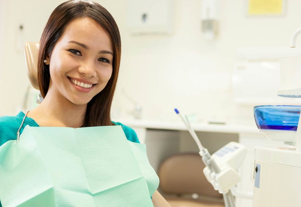 Young female dental patient at a teeth cleaning appointment