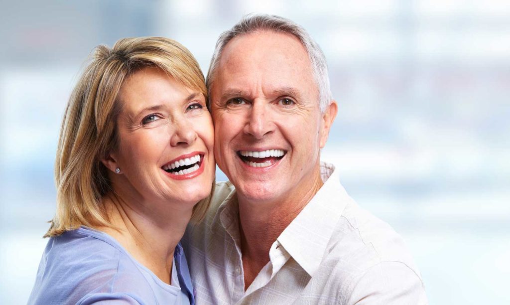 Older man and woman with smile makeovers