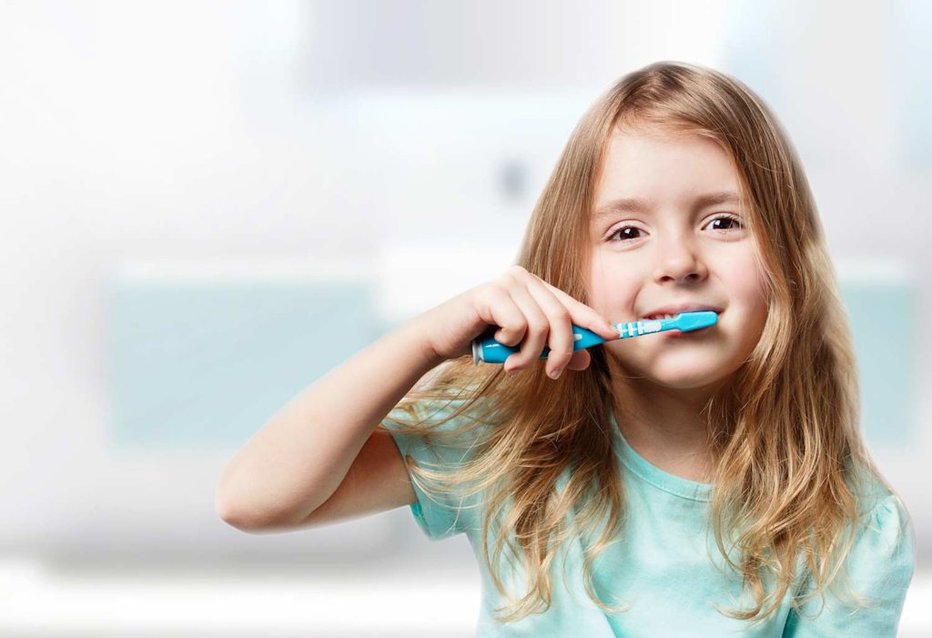 Young girl brushing her teeth